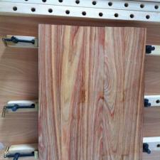 Now design the surface panel. Check the plank ends - you want the grain curvature to alternate between planks to minimize warping. Pay attention to how edges meet and fix mismatches with your plane. Your ultimate goal is to find an arrangement that looks as great as can be given the structural requirements. Make a mark across the panel so you can easily recreate it. My panel clamp is from <a href=http://www.leevalley.com/US/wood/page.aspx?p=31181&cat=1,43838">Lee Valley Tools</a>. Gluing up the table top