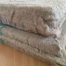 Corner view of two cushions clad in coffee bags - livingwiththewebers.com